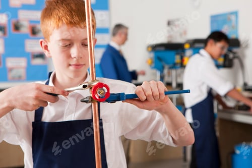 Preview: A Shot Of A Young Boy Using Wrench To Tighten Valve On A Cooper Pipe.