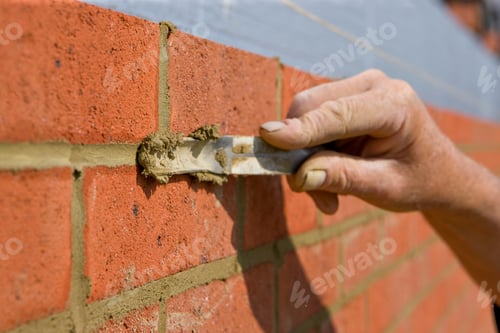 Preview: Close Up Of A Brick Wall And Jointer Trowel Used By The Worker To Apply And Level The Mortar