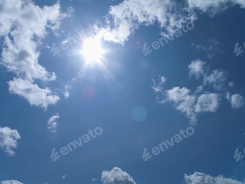 Preview: A Shot Of A Bright Sun Shining In A Blue Sky With Clouds.