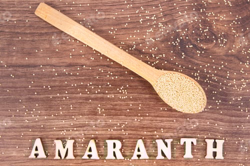 Preview: Amaranth Seeds with Wooden Spoon on Brown Background