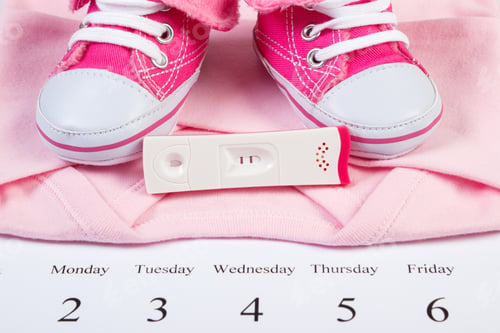 Preview: Pregnancy Test With Positive Result And Clothing For Newborn On Calendar, Concept Of Extending