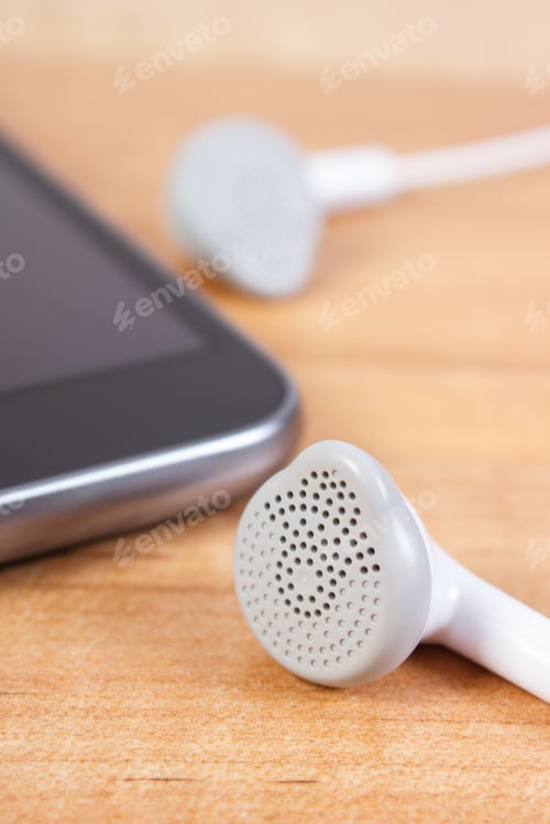 Preview: Mobile Phone, Smartphone With Headphones On Wooden Board
