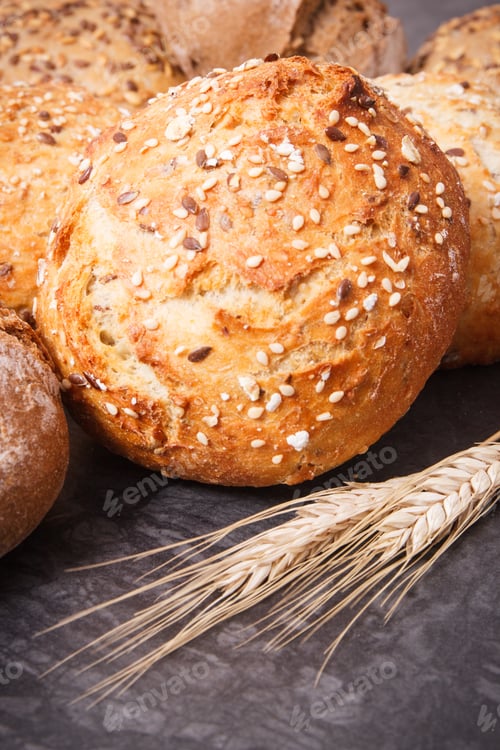 Preview: Fresh Baked Wholegrain Rolls With Seeds And Ears Of Rye Or Wheat Grain
