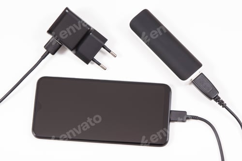 Preview: External Black Powerbank Or Electric Charger Charging Empty Battery Of Smartphone Or Mobile Phone