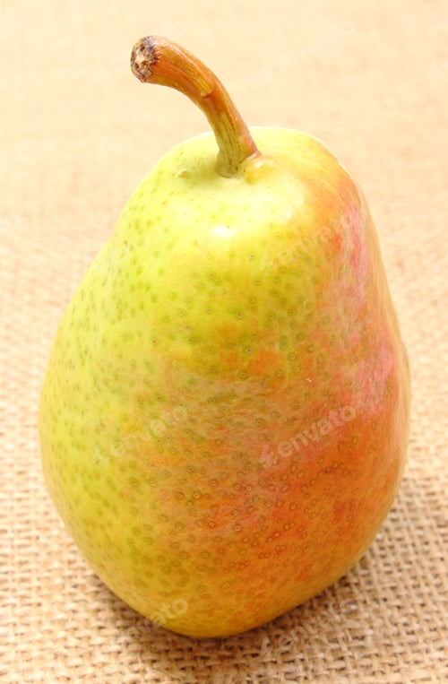 Preview: Fresh And Natural Pear Lying On Jute Canvas