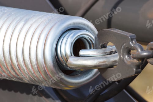 Preview: Closeup Of Steel Spring On Industrial Or Agricultural Machine, Detail And Part Of Hydraulic Or