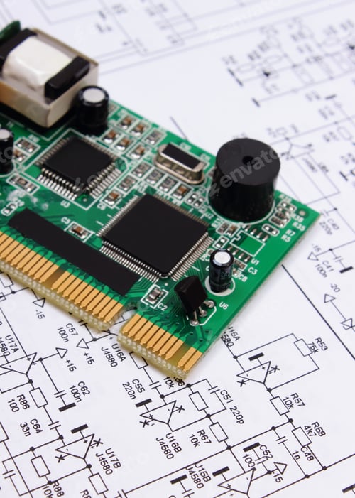 Preview: Printed Circuit Board With Electrical Components Lying On Construction Drawing Of Electronics