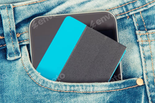 Preview: Credit Card And Mobile Phone For Cashless Paying In Pocket Of Blue Jeans. Finance And Banking