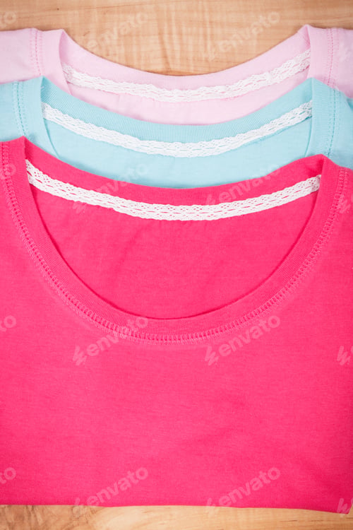 Preview: Colorful Shirts Or Sweater For Woman Lying On Rustic Boards