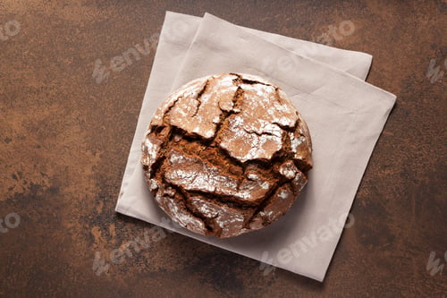 Preview: Loaf Of Fresh Bread On Napkin Cloth At Table. Bakery Food At Stone Rustic Background Texture With