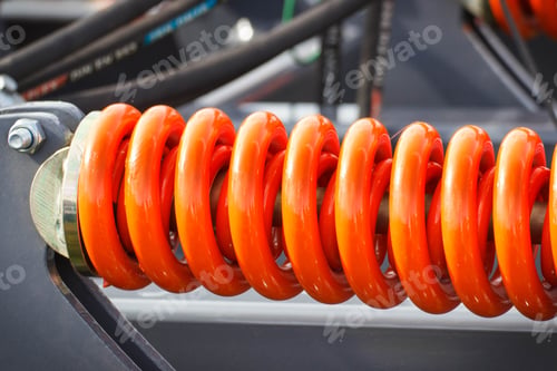 Preview: Hard Orange Spring Made Of Steel. Part And Detail Of Industrial Or Agricultural Machine. Technology