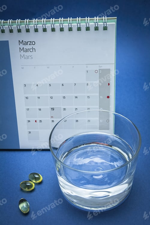 Preview: Glass Of Water And Pills Isolated On Blue