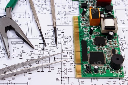 Preview: Printed Circuit Board With Electrical Components And Precision Tools Lying On Construction Drawing