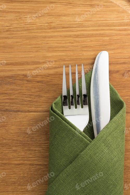 Preview: Knife And Fork At Napkin On Wooden Background