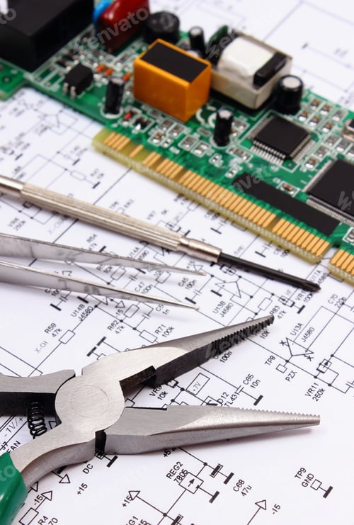 Preview: Printed Circuit Board With Electrical Components And Precision Tools Lying On Construction Drawing