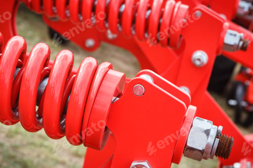 Preview: Big And Hard Red Steel Spring As Part And Detail Of Industrial Or Agricultural Machine. Technology