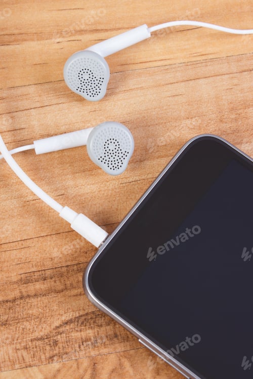 Preview: Mobile Phone, Smartphone With Headphones On Wooden Board