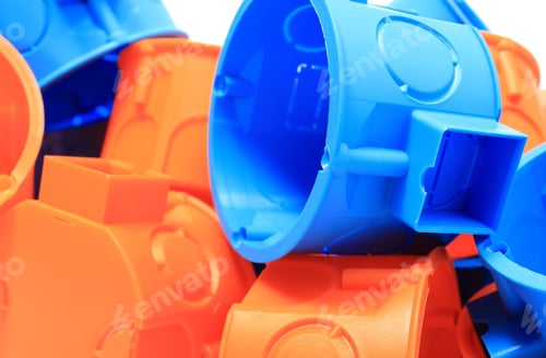 Preview: Heap Of Blue And Orange Plastic Electrical Boxes, Components For Electrical Installations