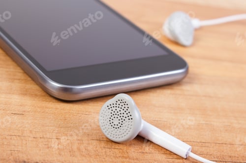 Preview: Mobile Phone, Smartphone With Headphones On Wooden Board