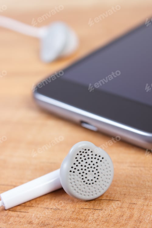 Preview: Mobile Phone, Smartphone With Headphones On Wooden Table