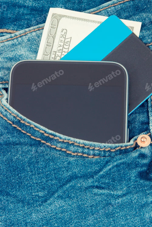 Preview: Credit Card, Currencies Dollar And Smartphone In Front Jeans Pocket. Concept Of Cashless Or Cash
