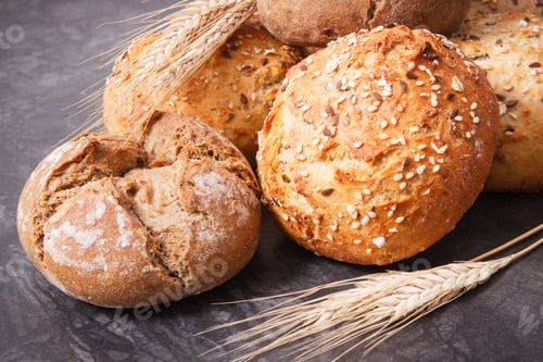 Preview: Fresh Baked Wholegrain Rolls With Seeds And Ears Of Rye Or Wheat Grain