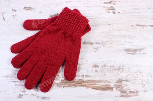 Preview: Pair Of Woolen Gloves For Woman On Old Rustic Wooden Background And Copy Space For Text, Womanly