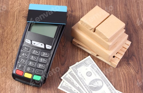 Preview: Payment Terminal With Contactless Credit Card, Currencies Dollar And Small Wrapped Boxes On Wooden
