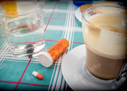 Preview: Medication During Breakfast, Capsules Next To A Glass Of Water, Conceptual Image, Horizontal