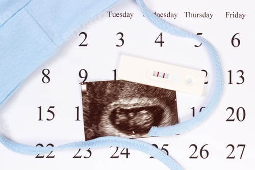 Preview: Pregnancy Test With Positive Result, Ultrasound Scan Of Baby And Clothing For Newborn On Calendar