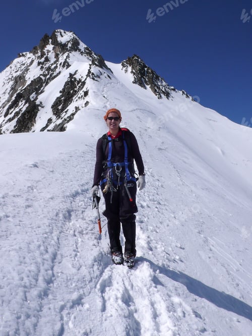 Preview: Female Climber Hiking Down Over A Glacier From A High Mountain Peak