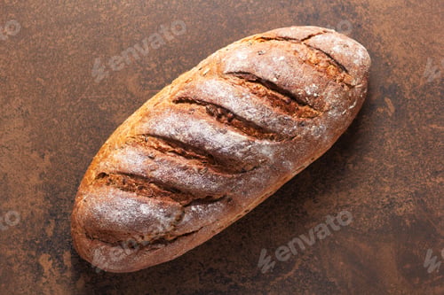 Preview: Loaf Of Fresh Bread On Table. Bakery Food At Stone Natural Background Texture. Flat Lay Top View