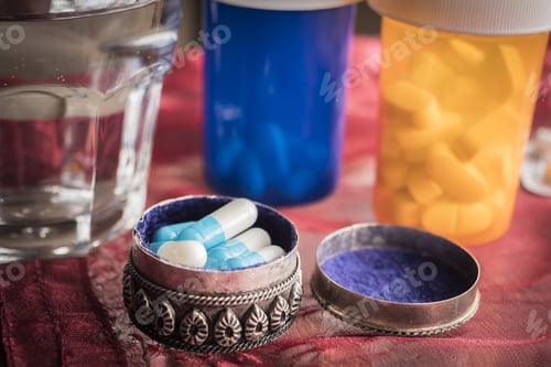 Preview: Metallic Pillbox With White Pills Along With Water Glass