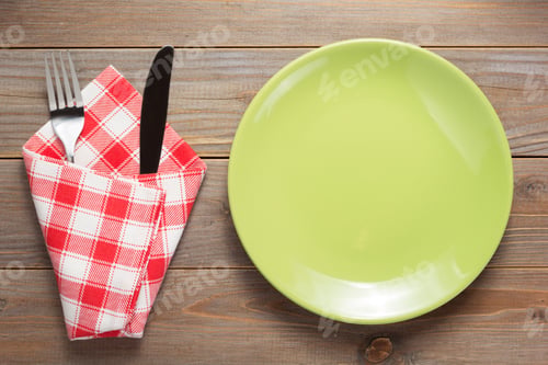 Preview: Plate, Knife And Fork At Rustic Wooden Plank Board Table Background, Top View