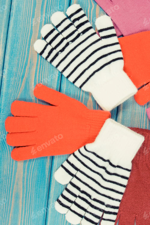 Preview: Colorful Woolen Gloves For Woman On Blue Boards, Warm Clothing For Autumn Or Winter Concept