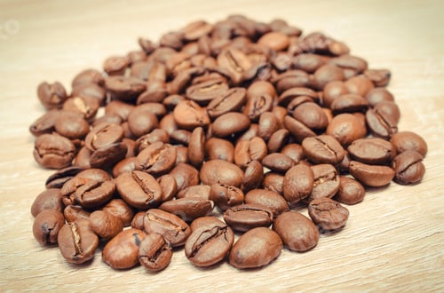 Preview: Heap Of Roasted Coffee Grains On Wooden Board