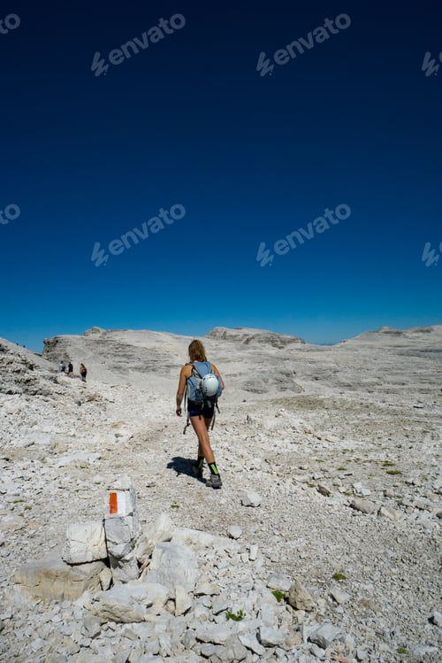 Preview: Female Mountain Climber Hikes Across A Wild Rock Desert High Mountain Plateau In The Dolomites