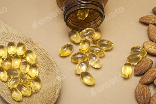 Preview: Almond Oil In Capsules Isolated On Brown Background