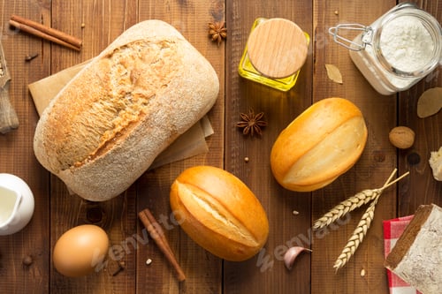 Preview: Bread And Bakery Ingredients On Wooden Table Background, Top View