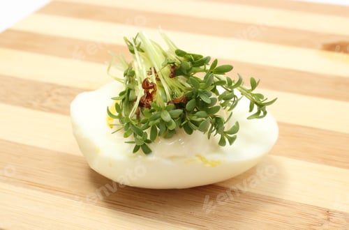 Preview: Halves Of Egg With Mayonnaise And Fresh Green Cress Lying On Wooden Cutting Board, Watercress