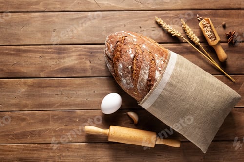 Preview: Loaf Of Fresh Bread And Bakery Ingredients For Homemade Baking On Wooden Table. Baker Food Set At