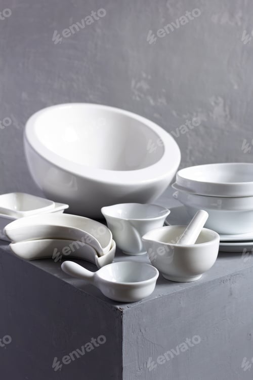 Preview: Empty Crockery Or Ceramic Dishes Set. Kitchen Dishware And Tableware On Grey Surface Near Wall