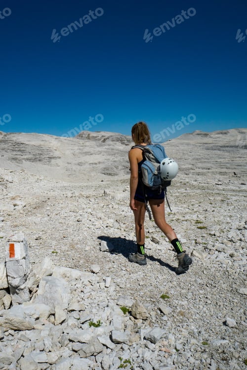 Preview: Female Mountain Climber Hikes Across A Wild Rock Desert High Mountain Plateau In The Dolomites