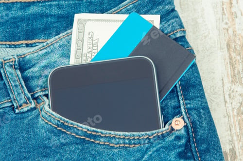 Preview: Credit Card, Money And Mobile Phone In Front Jeans Pocket. Concept Of Cashless Or Cash Paying For