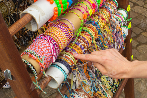 Preview: Hand Of Woman With Colorful Bracelets, Shopping Jewelry And Womanly Accessories On Stall At The