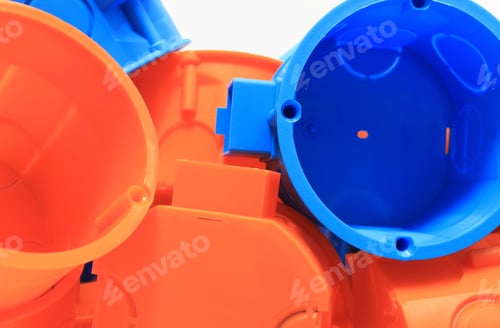 Preview: Heap Of Blue And Orange Plastic Electrical Boxes, Components For Electrical Installations