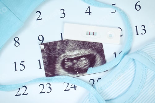 Preview: Pregnancy Test With Positive Result, Ultrasound Scan Of Baby And Clothing For Newborn On Calendar