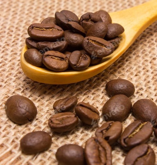 Preview: Heap Of Coffee Beans On Wooden Spoon Lying On Jute Canvas, Coffee Grains
