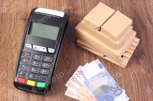 Preview: Payment Terminal, Currencies Euro And Small Wrapped Boxes On Wooden Pallet, Concept Of Paying For
