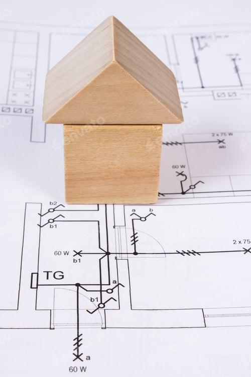 Preview: House Shape Made Of Wooden Blocks Lying On Electrical Construction Drawings Of House, Concept Of